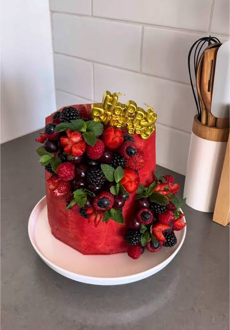 Berry-draped tier with a gold topper